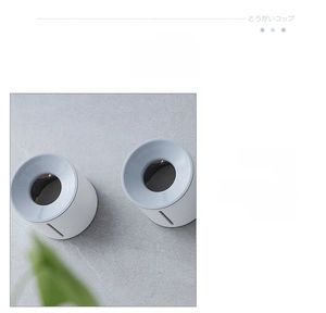 Close-up of the grey and white bathroom holder showing large diameter drainage holes