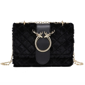 Black plush crossbody bag with chain strap and golden antler deer head decoration
