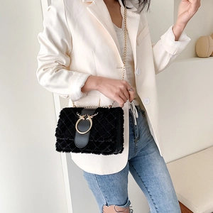 Fashionable black faux fur crossbody bag with gold chain strap and deer metal ornament
