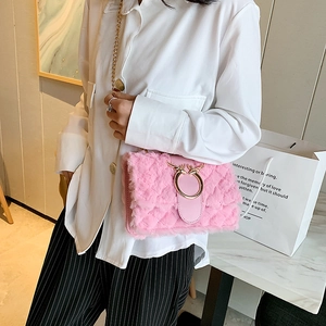 Pink plush crossbody bag featuring gold reindeer antler buckle and metal chain strap