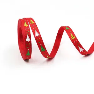 Macro detail of 10mm red grosgrain ribbon featuring festive Christmas tree patterns