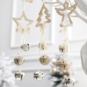 Glittery gold star tree and angel ornaments with metallic bells for Christmas decor