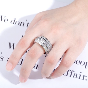 Close-up of triple-row baguette cut silver ring with micro-pave setting on hand