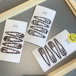 Set of 12 snap hair clips featuring leopard, zebra, and checkered prints on cards