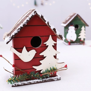 Charming wooden Christmas cabin birdhouse ornament with snow finish and red berry details