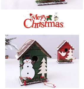 Detailed view of handmade wooden Christmas cabin ornaments with snowman and festive decor