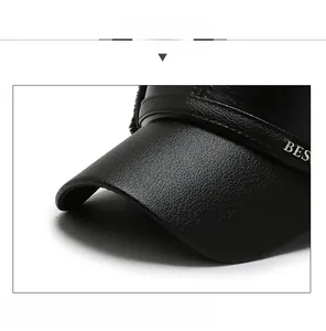 Detail of black leather visor with lychee texture and metallic BES buckle on winter cap