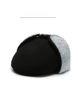 Close-up of winter flat cap featuring grey faux fur ear flaps and adjustable black buckle