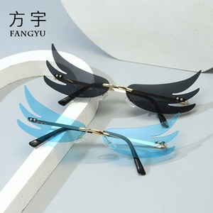 Detailed macro shot of frameless wing-shaped sunglasses with metal hinges and blue lenses