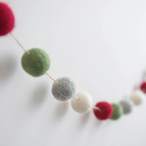 Handmade wool felt ball garland in red green grey and white for Nordic Christmas decor
