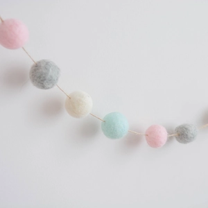Macaron wool felt ball garland in pink, grey, and white for Nordic Christmas decor