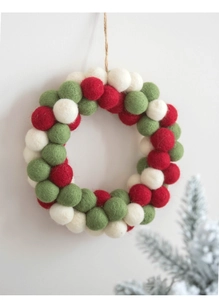 Detail of wool felt ball Christmas wreath with red white and green balls for home decor