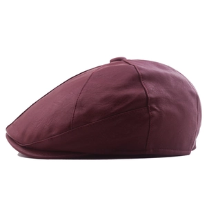 Classic dark red PU leather newsboy cap with premium stitching on white background