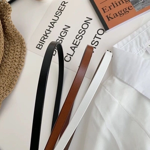 Minimalist skinny waist belts for women in black, brown and white leather options