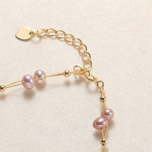 Elegant gold-tone chain bracelet with pink freshwater pearls and heart-shaped pendant