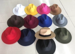 Flat lay of diverse wide brim wool fedora hats in multiple colors for autumn and winter