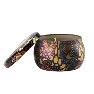 Decorative aromatherapy soy candle in a tin with intricate floral patterns and gold details