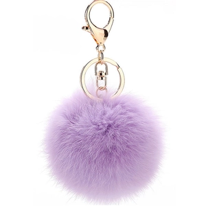 Detail of light purple fluffy pom-pom keychain with golden metal spring hook and ring