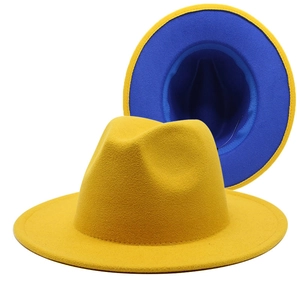 Detail of wool fedora hats in solid yellow and blue contrast with classic flat brim style