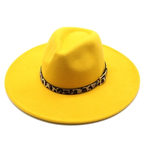 Detail of yellow wool fedora hat with leopard print band and golden buckle finish