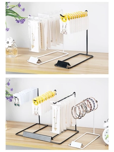 Detail of black and white metal jewelry display stands for necklaces and earrings