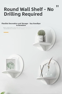 Three circular white wall shelves in tiered layout displaying plants and frames