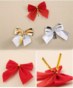 Close-up of red flocked Christmas bows with metallic wire ties for tree decoration