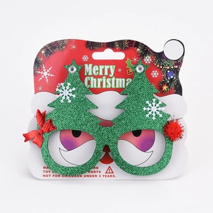 Detail of Christmas tree glasses with red and green glitter fabric and Merry Christmas text