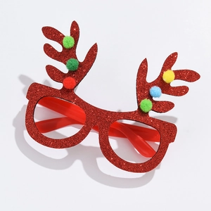 Detail of red Christmas antler glasses featuring glitter finish and colorful pom-poms