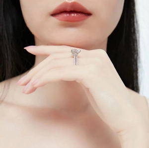 Elegant teardrop cubic zirconia engagement ring in silver finish worn by a model