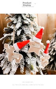 Rustic burlap reindeer and star ornaments with red hats on a snowy Christmas tree branch