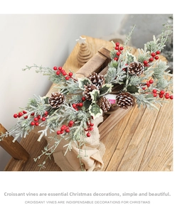 Close-up of Christmas rattan with frosted needles, red berries and natural pine cones