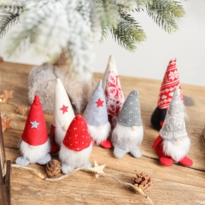 Charming Christmas Gnomes set with knitted hats on rustic wood and snowy pine background