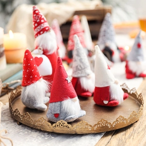 Set of Christmas Tomte gnomes in red, grey and white on a vintage golden tray