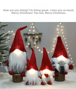 Close-up of glowing LED nose on plush Christmas Rudolf gonks with red knitted hats