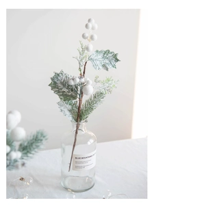 Frosted white berry picks with pine needles in a glass vase for Christmas home decor