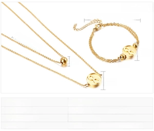 Detail of gold stainless steel infinity symbol necklace and bracelet set with round beads