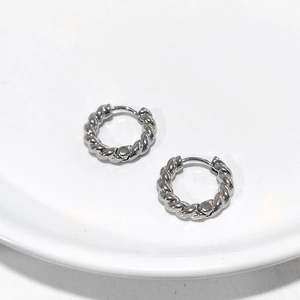 Silver twisted rope hoop earrings with spiral texture on minimalist white background