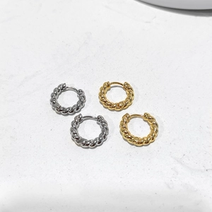 Detail view of twisted rope hoop earrings in polished gold and silver finishes