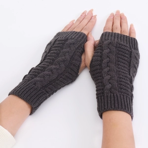 Detailed cable knit texture of dark grey fingerless gloves with ribbed wrist cuffs