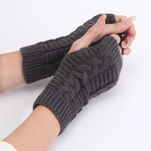 Detail view of dark grey cable knit pattern on warm winter fingerless gloves