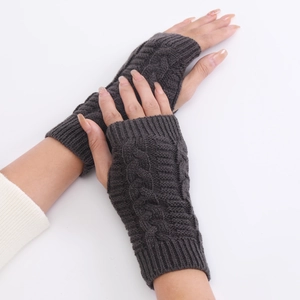 Macro shot of dark grey cable knit pattern on fingerless gloves for winter warmth