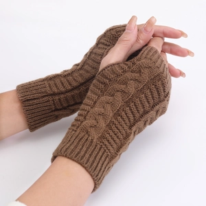 Close-up of brown cable knit fingerless gloves showing warm textured knit details
