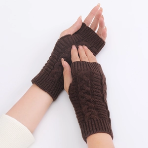 Detailed close-up of dark brown cable-knit fingerless gloves with texture and cuff design