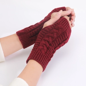 Detailed close-up of red cable knit arm warmers showing soft wool texture and fingerless design