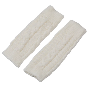 Close-up of cream cable knit fingerless gloves showing detailed texture and soft wool