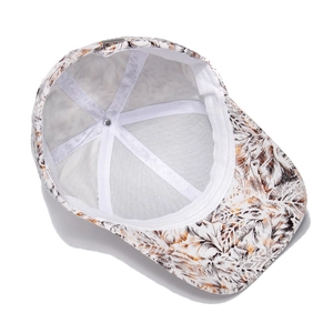 White cotton baseball cap with tropical leaf print showing interior mesh and seam detail