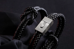 Close-up of black braided leather rope bracelet with brushed metal magnetic buckle