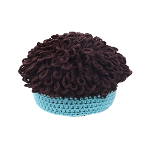 Detailed view of handmade crochet knit baby hat with brown curly texture and blue rim