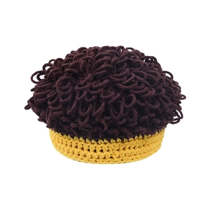 Close-up of knit baby wig hat showing coffee and yellow textured yarn details
